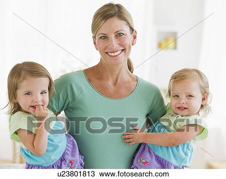 Stock Image - Portrait of mother with daughters (2-3). Fotosearch