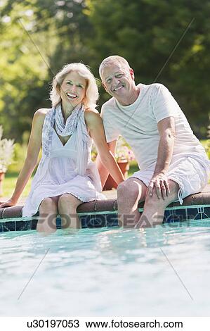 Portrait of senior couple at edge of swimming pool View Large Photo Image Stock Image - Portrait of senior couple at edge of swimming pool. Fotosearch