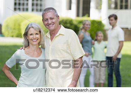Portrait of senior couple, family in background View Large Photo Image Picture - Portrait of senior couple, family in background. Fotosearch