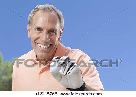 Portrait of senior man holding golf ball View Large Photo Image Stock Photo - Portrait of senior man holding golf ball. Fotosearch