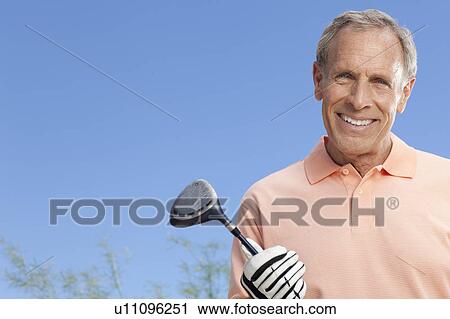 Portrait of senior man holding golf club View Large Photo Image Stock Image - Portrait of senior man holding golf club. Fotosearch