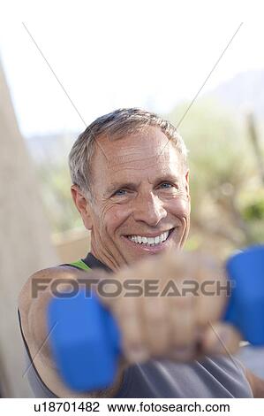 Portrait of senior man lifting dumbbells View Large Photo Image Stock Image - Portrait of senior man lifting dumbbells. Fotosearch