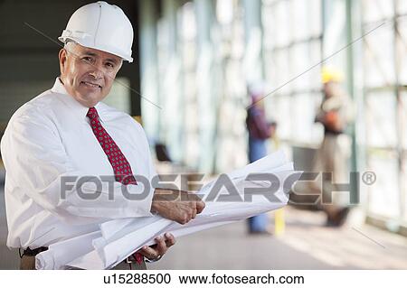 Portrait of senior man wearing tie and hardhat, holding blueprint View Large Photo Image Stock Image - Portrait of senior man wearing tie and hardhat, holding blueprint. Fotosearch