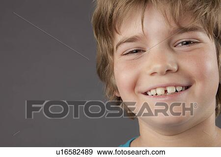 Portrait of smiling boy (8-9), studio shot View Large Photo Image Stock Photo - Portrait of smiling boy (8-9), studio shot. Fotosearch