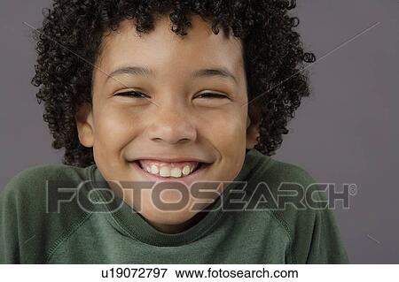 Portrait of smiling boy (8-9), studio shot View Large Photo Image Stock Photo - Portrait of smiling boy (8-9), studio shot. Fotosearch