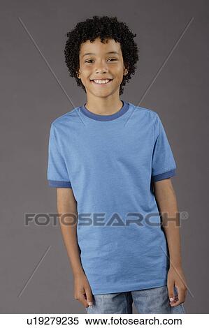 Stock Photography - Portrait of smiling boy (8-9), studio shot. Fotosearch