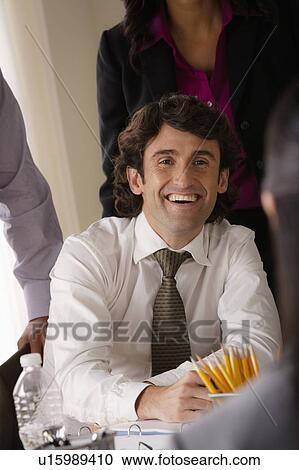 Portrait of smiling businessman in office View Large Photo Image Stock Image - Portrait of smiling businessman in office. Fotosearch