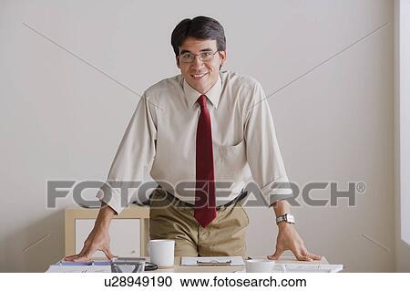 Portrait of smiling businessman in office View Large Photo Image Stock Image - Portrait of smiling businessman in office. Fotosearch