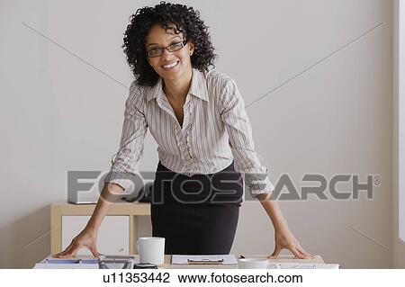 Portrait of smiling businesswoman in office View Large Photo Image Stock Image - Portrait of smiling businesswoman in office. Fotosearch