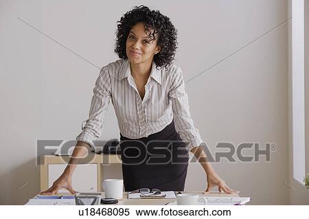 Portrait of smiling businesswoman in office View Large Photo Image Stock Photography - Portrait of smiling businesswoman in office. Fotosearch