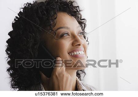 Stock Image - Portrait of smiling businesswoman on phone. Fotosearch