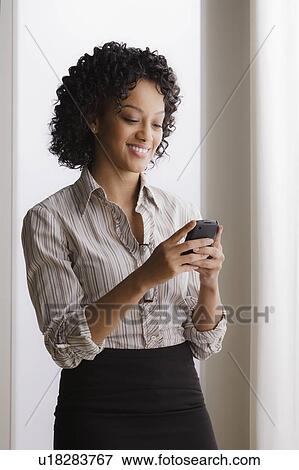 Stock Photo - Portrait of smiling businesswoman on phone. Fotosearch