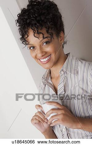 Portrait of smiling businesswoman holding mug View Large Photo Image Stock Photograph - Portrait of smiling businesswoman holding mug. Fotosearch