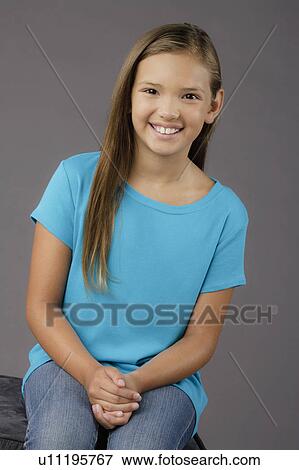 Portrait of smiling girl (8-9), studio shot View Large Photo Image Stock Photo - Portrait of smiling girl (8-9), studio shot. Fotosearch