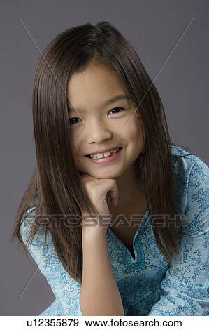 Portrait of smiling girl (8-9), studio shot View Large Photo Image Stock Photo - Portrait of smiling girl (8-9), studio shot. Fotosearch