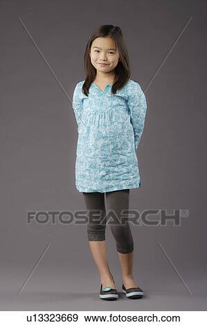 Portrait of smiling girl (8-9), studio shot View Large Photo Image Stock Photo - Portrait of smiling girl (8-9), studio shot. Fotosearch