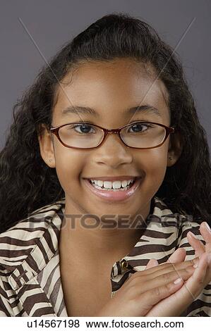 Portrait of smiling girl (8-9), studio shot View Large Photo Image Stock Photo - Portrait of smiling girl (8-9), studio shot. Fotosearch