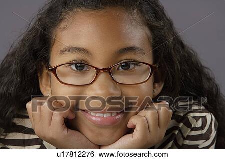 Portrait of smiling girl (8-9), studio shot View Large Photo Image Stock Photograph - Portrait of smiling girl (8-9), studio shot. Fotosearch