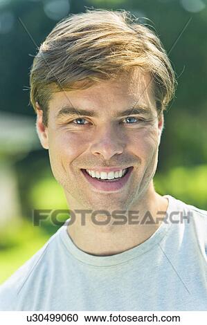 Stock Image - Portrait of smiling mid adult man. Fotosearch