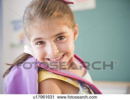 Stock Image - Portrait of smiling schoolgirl ( 6-7). Fotosearch
