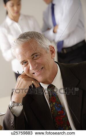 Stock Image - Portrait of smiling senior businessman. Fotosearch