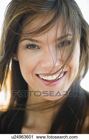 Stock Image - Portrait of smiling woman. Fotosearch