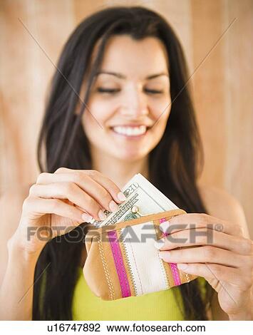 Portrait of smiling woman taking money from purse View Large Photo Image Stock Image - Portrait of smiling woman taking money from purse. Fotosearch