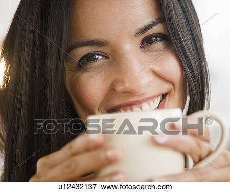 Stock Photo - Portrait of smiling woman with cup. Fotosearch