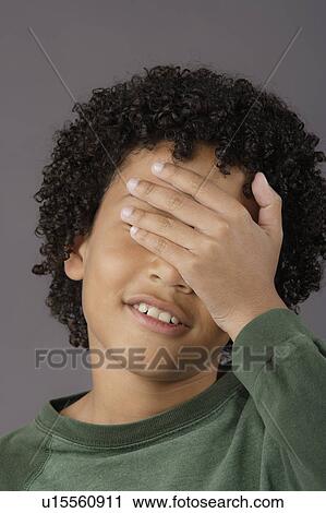 Stock Image - Portrait of surprised boy (8-9), studio shot. Fotosearch
