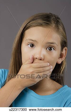 Stock Image - Portrait of surprised girl (8-9), studio shot. Fotosearch