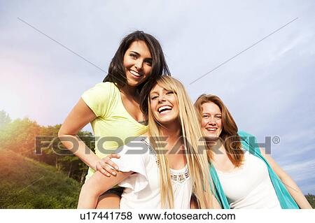 Portrait of three young women hanging out View Large Photo Image Stock Photo - Portrait of three young women hanging out. Fotosearch