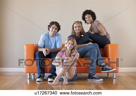 Portrait of two couples sitting on sofa View Large Photo Image Stock Image - Portrait of two couples sitting on sofa. Fotosearch