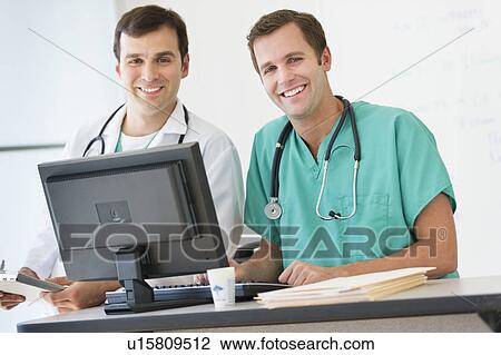 Portrait of two doctors using computer View Large Photo Image Stock Image - Portrait of two doctors using computer. Fotosearch