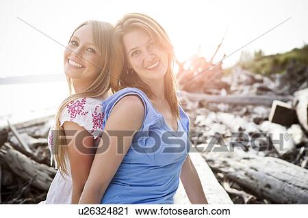 Portrait of two young women on beach View Large Photo Image Stock Image - Portrait of two young women on beach. Fotosearch
