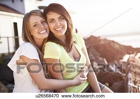 Stock Image - Portrait of two young women smiling. Fotosearch