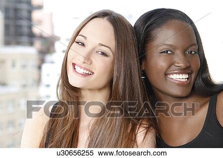 Portrait of two young women smiling View Large Photo Image Stock Photography - Portrait of two young women smiling. Fotosearch