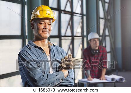 Portrait of worker wearing hardhat View Large Photo Image Stock Image - Portrait of worker wearing hardhat. Fotosearch