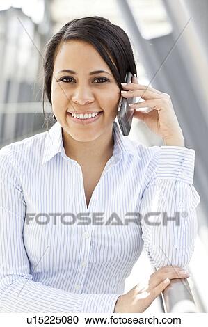 Portrait of young businesswoman talking on phone View Large Photo Image Stock Image - Portrait of young businesswoman talking on phone. Fotosearch