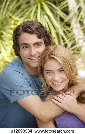 Portrait of young couple in park View Large Photo Image Picture - Portrait of young couple in park. Fotosearch