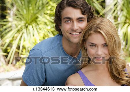 Portrait of young couple in park View Large Photo Image Stock Image - Portrait of young couple in park. Fotosearch