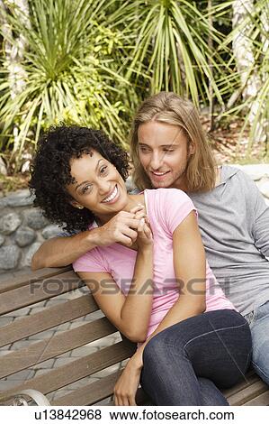 Portrait of young couple in park View Large Photo Image Stock Photo - Portrait of young couple in park. Fotosearch
