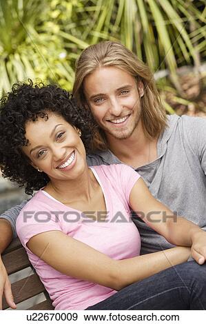 Portrait of young couple in park View Large Photo Image Stock Photo - Portrait of young couple in park. Fotosearch