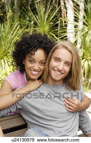 Stock Photo - Portrait of young couple in park. Fotosearch