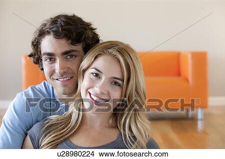 Picture - Portrait of young couple in room. Fotosearch