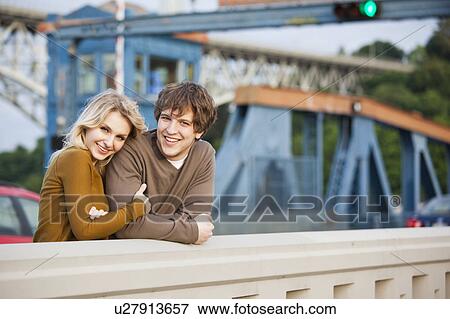 Portrait of young couple on bridge View Large Photo Image Stock Photo - Portrait of young couple on bridge. Fotosearch