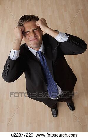 Stock Image - Portrait of young frustrated businessman . Fotosearch