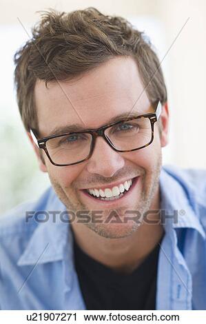 Portrait of young man wearing glasses View Large Photo Image Stock Image - Portrait of young man wearing glasses. Fotosearch