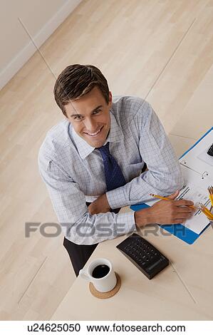 Portrait of young smiling businessman in office View Large Photo Image Stock Image - Portrait of young smiling businessman in office. Fotosearch