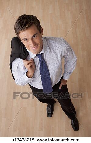 Portrait of young smiling businessman in office View Large Photo Image Stock Photography - Portrait of young smiling businessman in office. Fotosearch