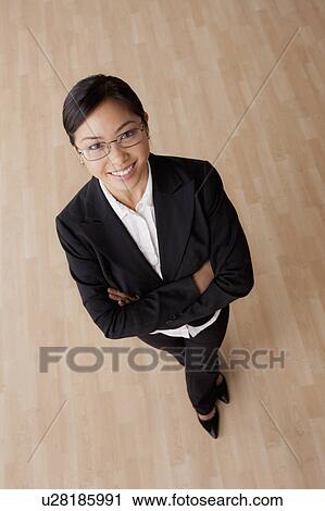 Stock Image - Portrait of young smiling businesswoman. Fotosearch